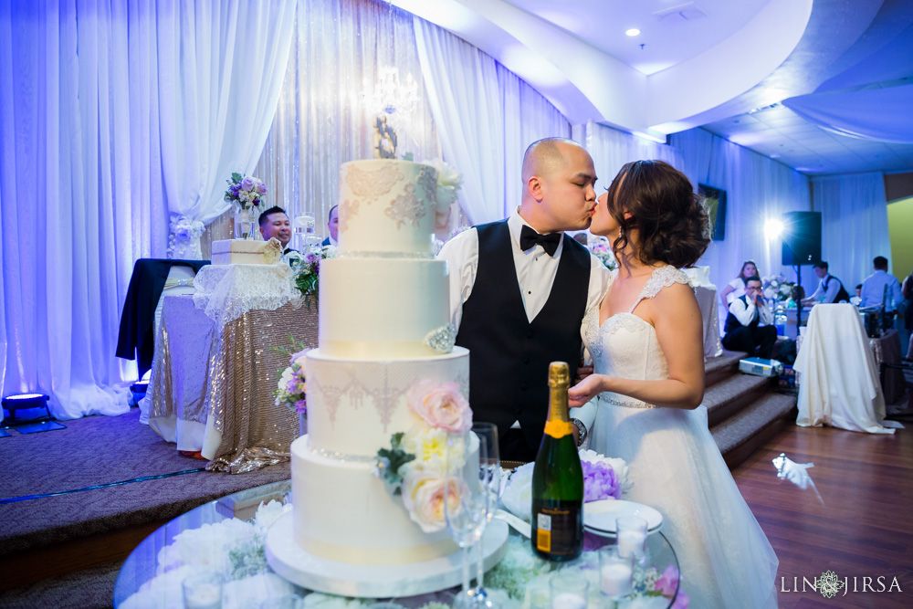 Couple Next to Wedding Cake with Wedding Uplighting