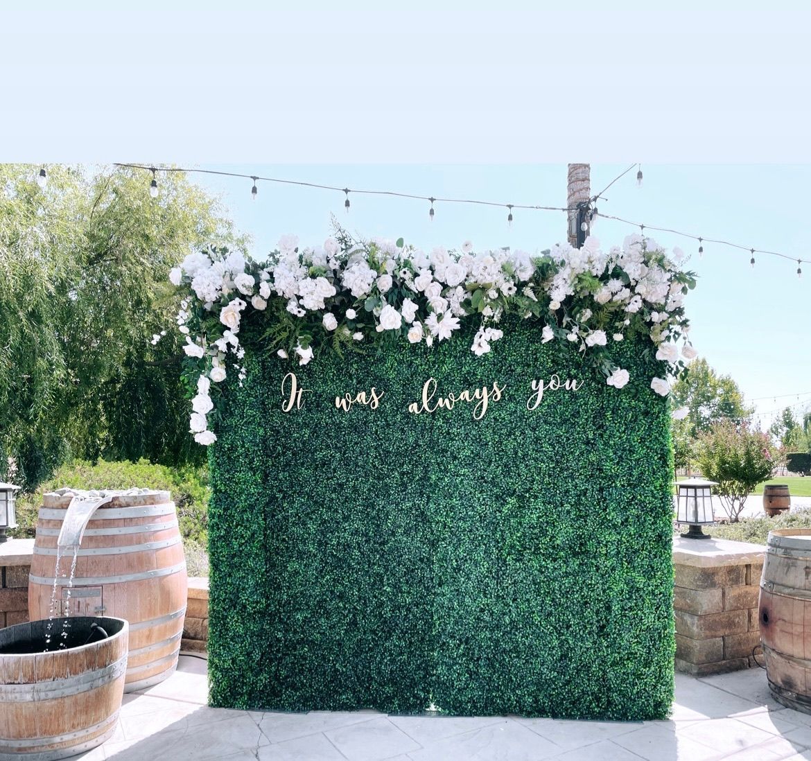 A green wall with white flowers and the words `` i was always you '' written on it.