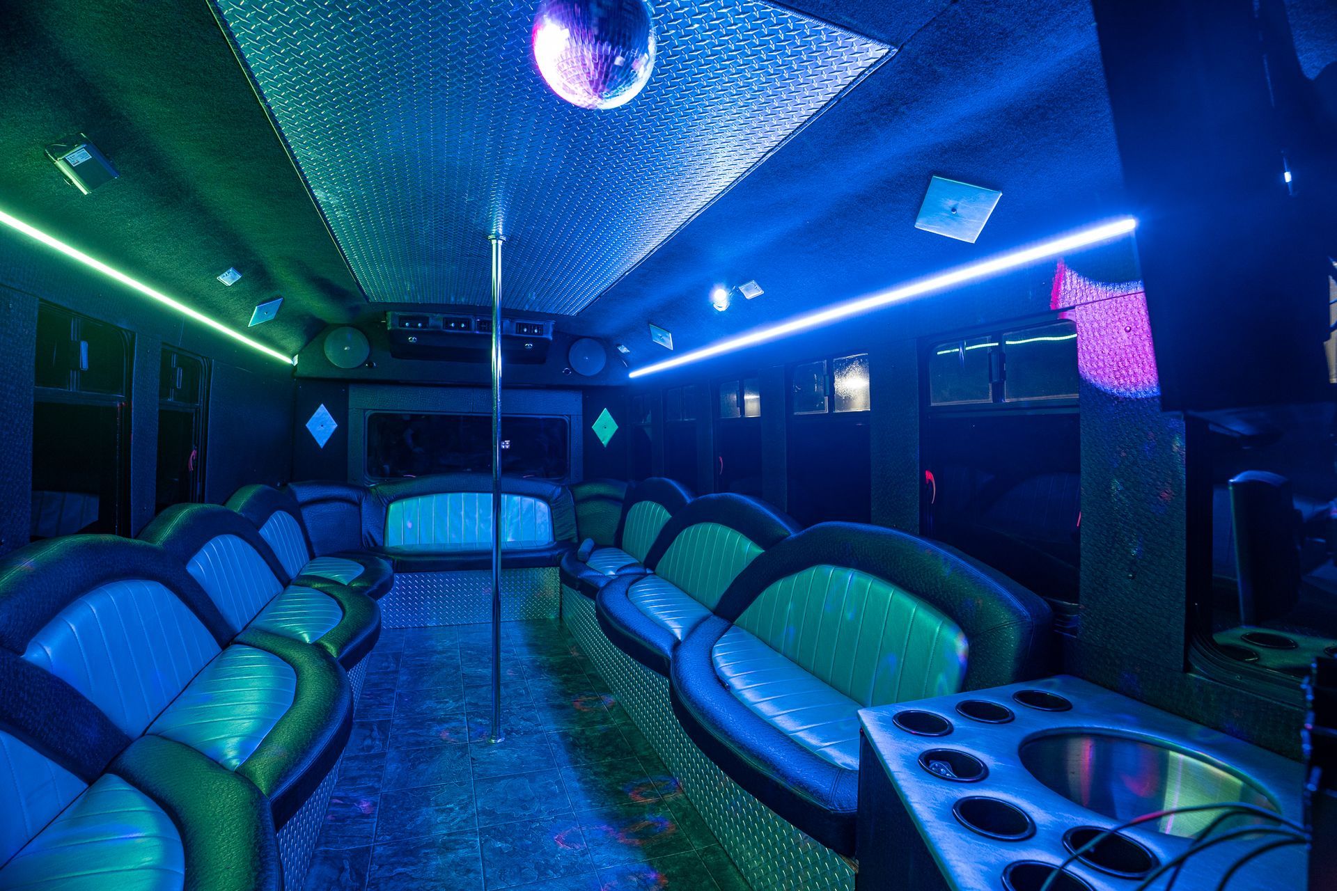 A disco ball is hanging from the ceiling of a party bus