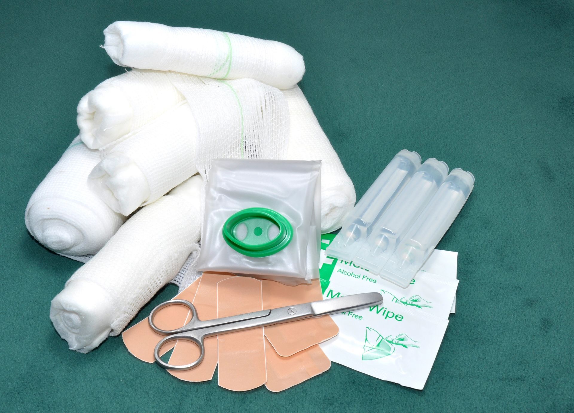 A stack of bandages and a pair of scissors on a table