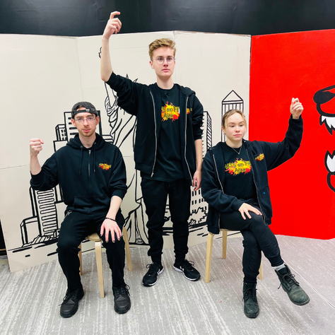 Three people in black hoodies and pants, raising hands. Backgrounds include a cityscape and a red graphic.