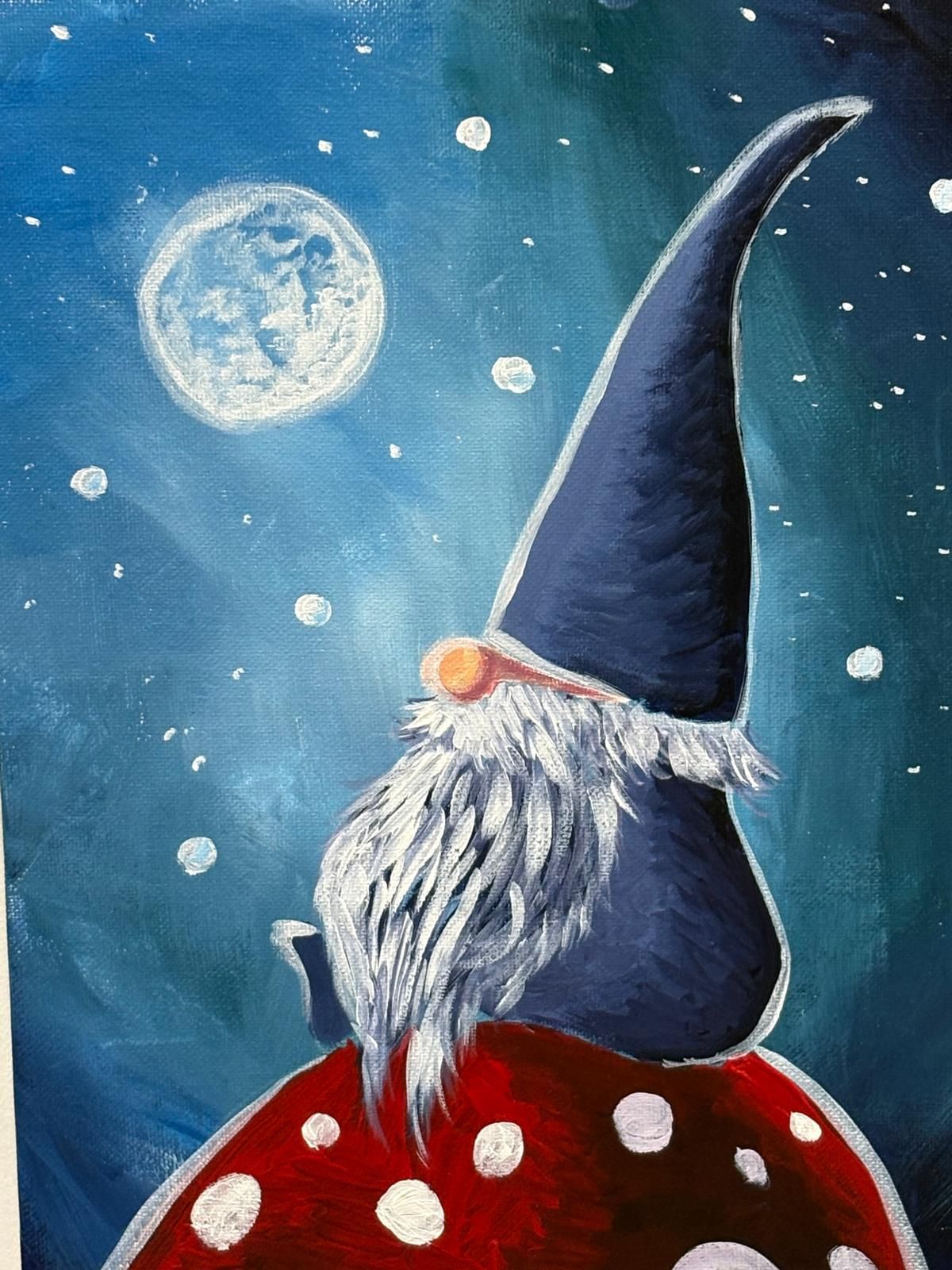 Gnome sits atop red mushroom, gazing at full moon in starry blue sky.