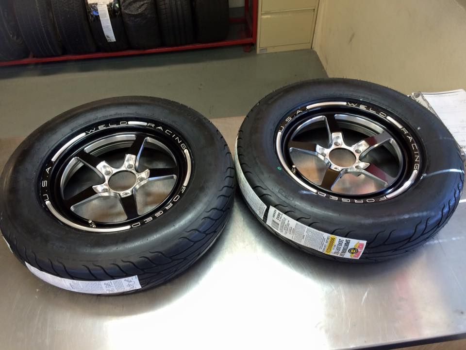 Two Tires And Wheels On A Table — Rallimax Wheel Repairs & Alignments in Fyshwick, ACT