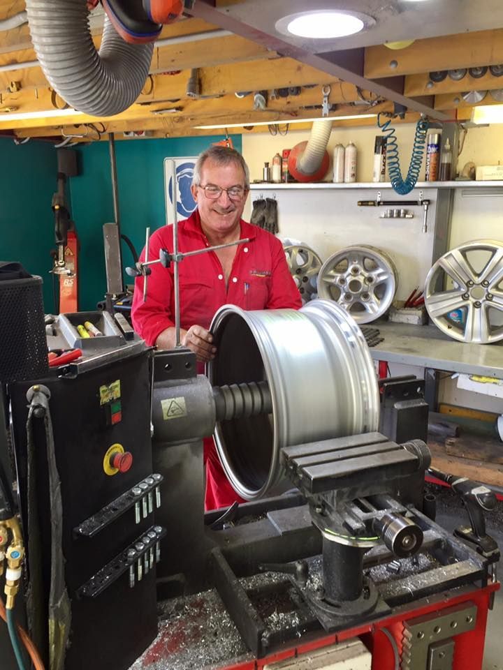 Worker Repairing Wheel — Rallimax Wheel Repairs & Alignments in Fyshwick, ACT