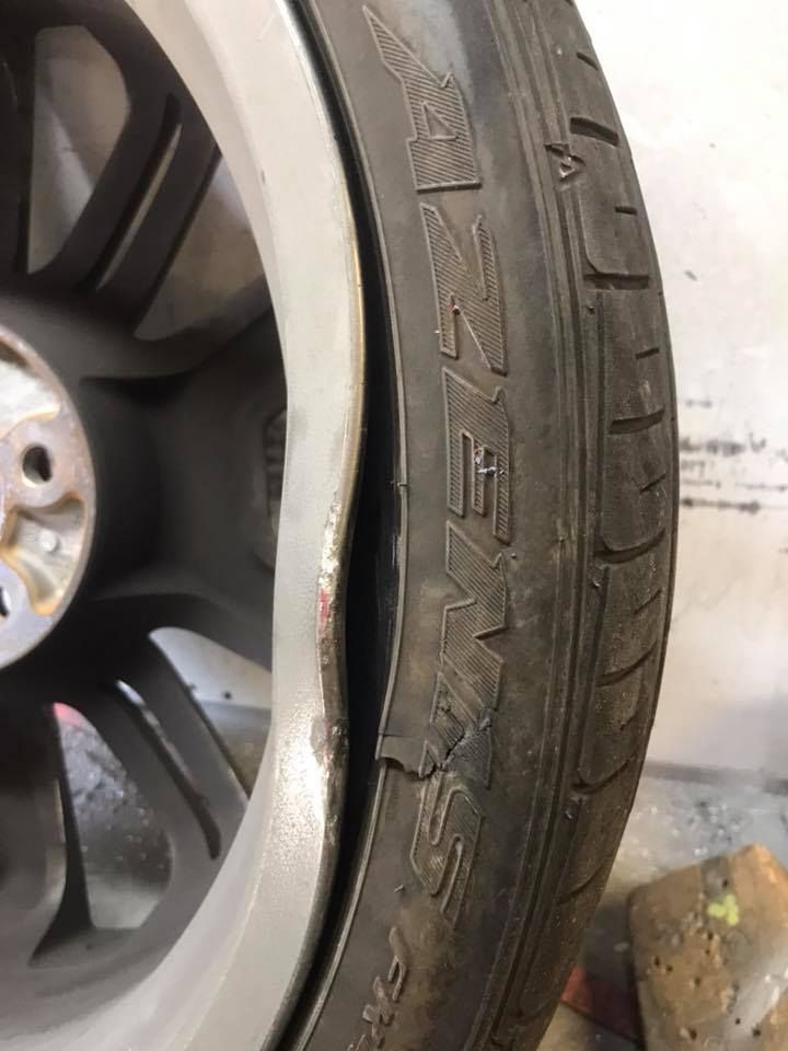 A Close Up Of A Damaged Tyre On A Car Wheel — Rallimax Wheel Repairs & Alignments in Yass, NSW