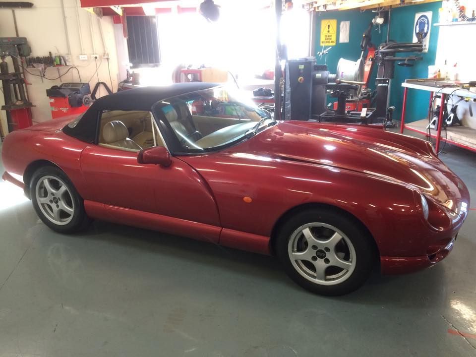 A Red Sports Car With A Black Top Is Parked In A Garage — Rallimax Wheel Repairs & Alignments in Yass, NSW