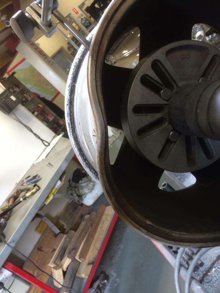 A Close Up Of A Damaged Wheel In A Garage — Rallimax Wheel Repairs & Alignments in Gundagai, NSW
