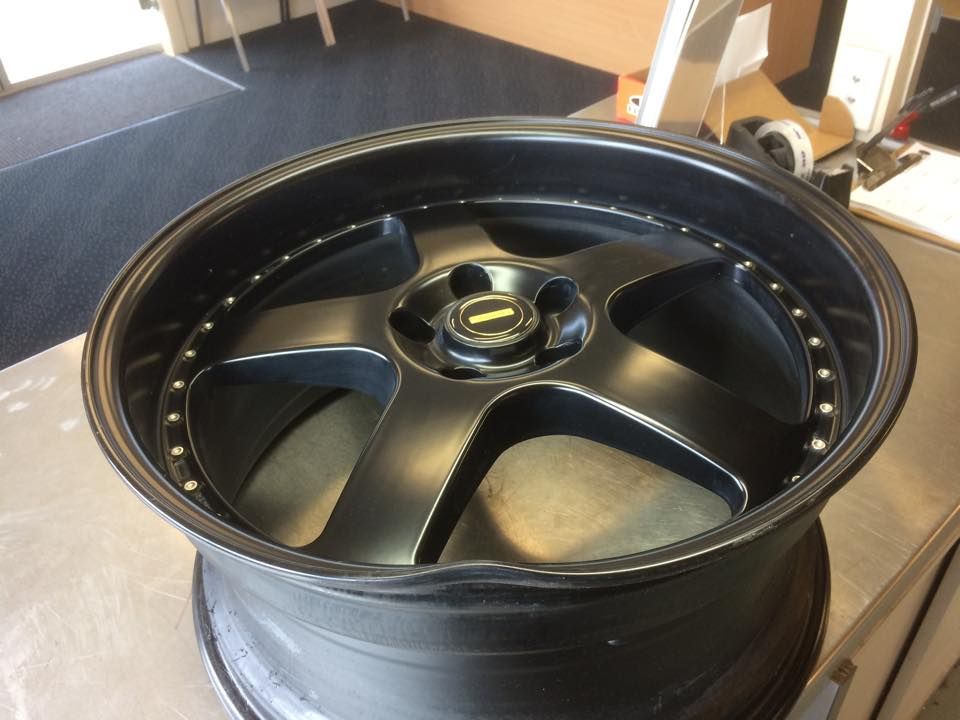 A Close Up Of A Damaged Black Wheel On A Table — Rallimax Wheel Repairs & Alignments in Cootamundra, NSW