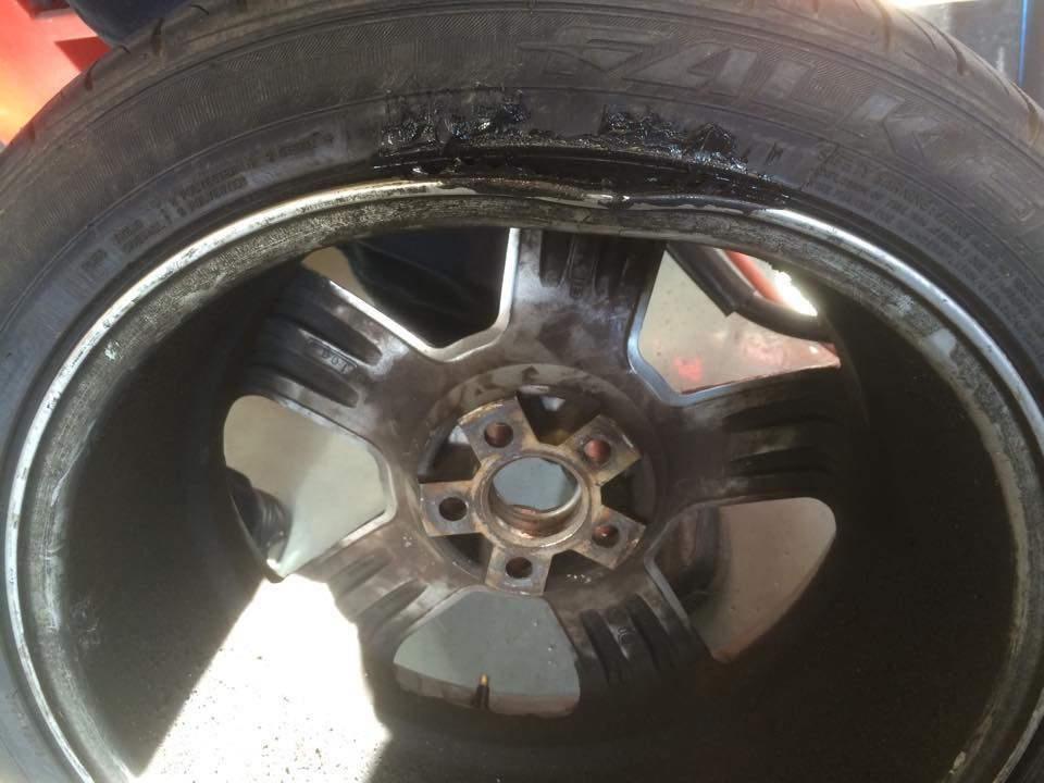 A Close Up Of A Damaged Car Wheel With A Tyre On It — Rallimax Wheel Repairs & Alignments in Wagga Wagga, NSW