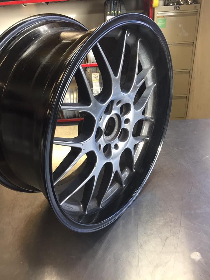 A Black And Silver Wheel Is Sitting On A Table — Rallimax Wheel Repairs & Alignments in Yass, NSW