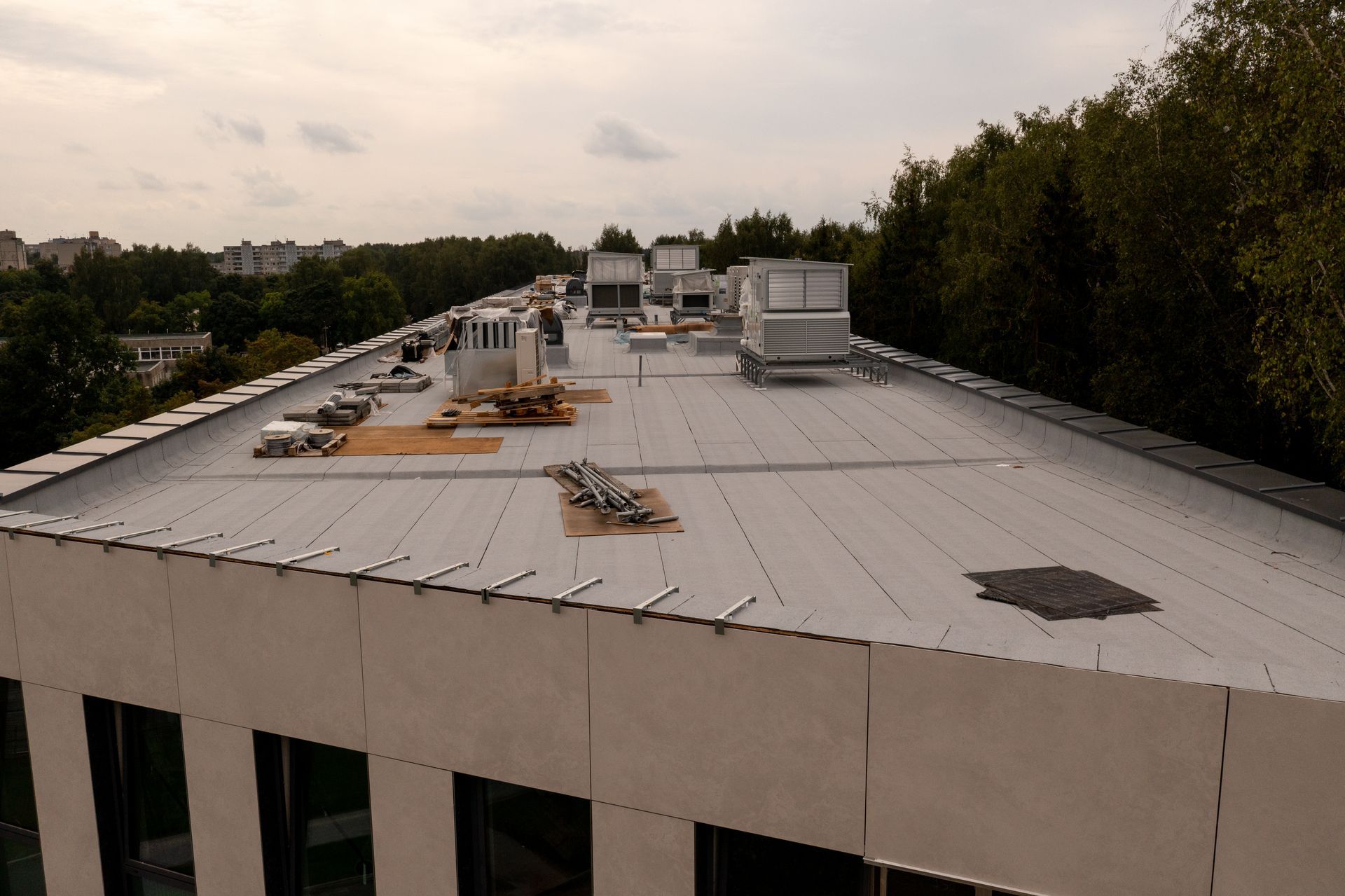 The roof of a building with trees in the background