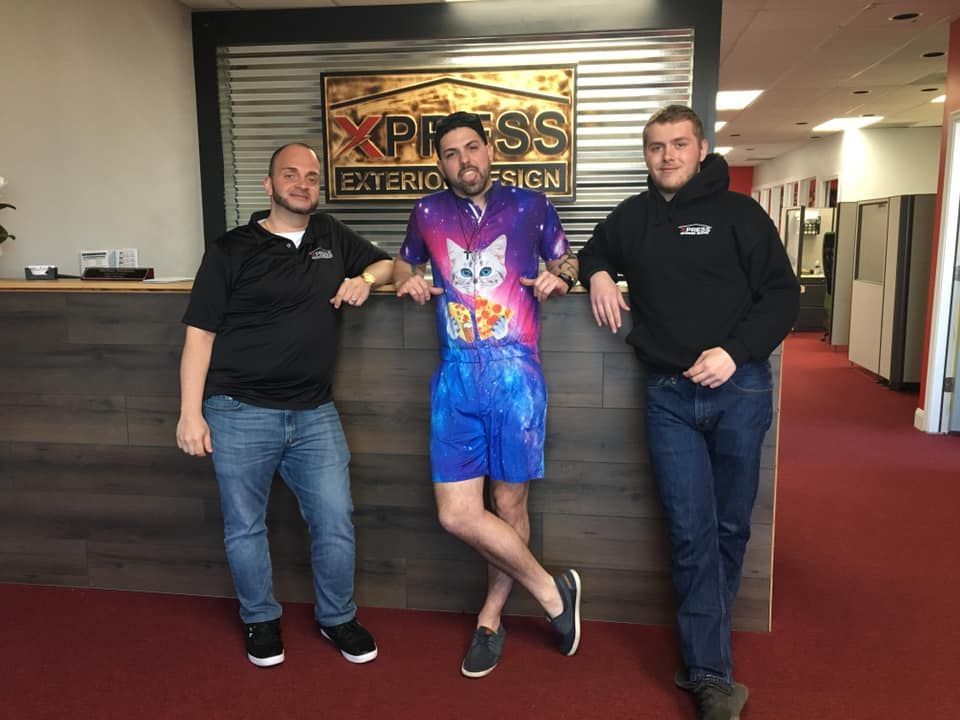 Dakota Brokhoff posing for a picture in front of a sign that says express