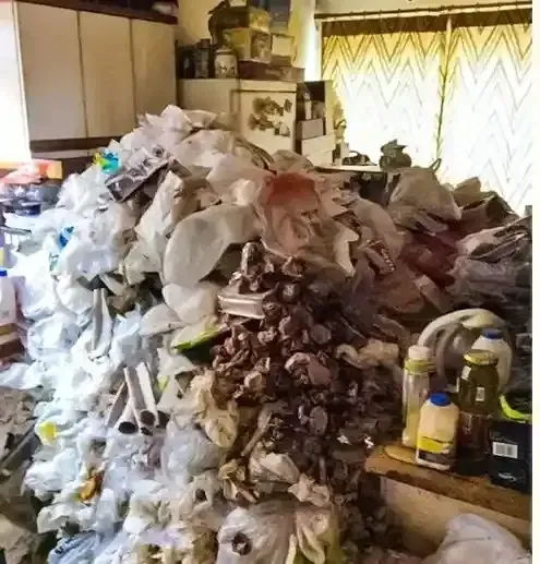 A pile of trash is sitting on a table in a room.