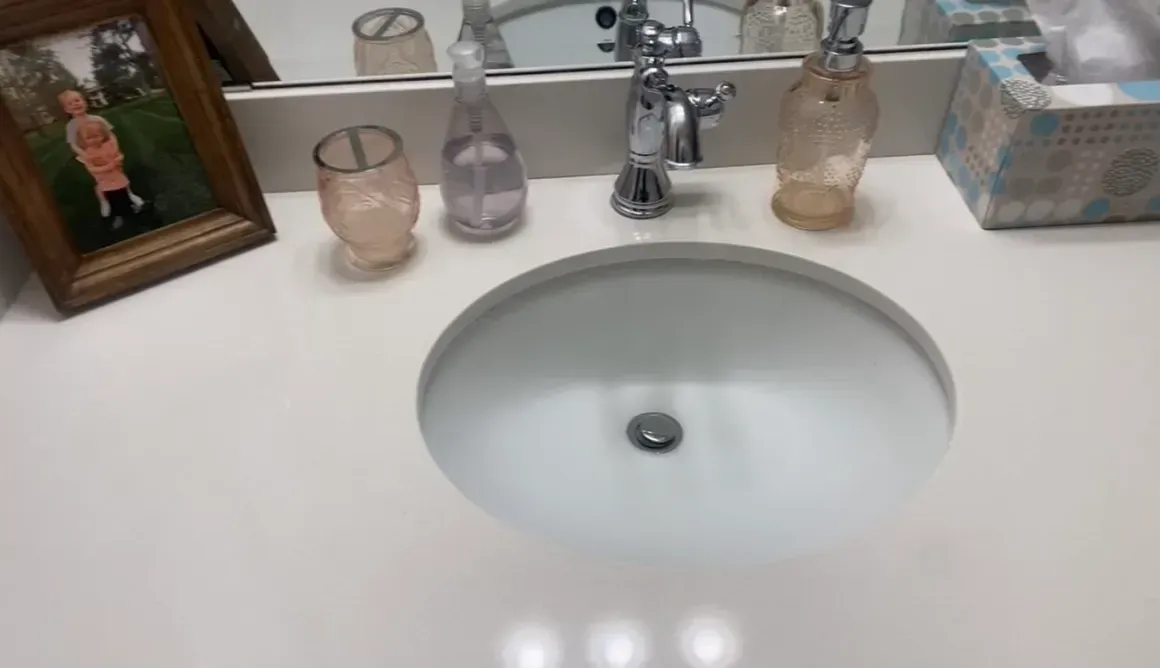 A bathroom sink with a picture of a child on the counter.