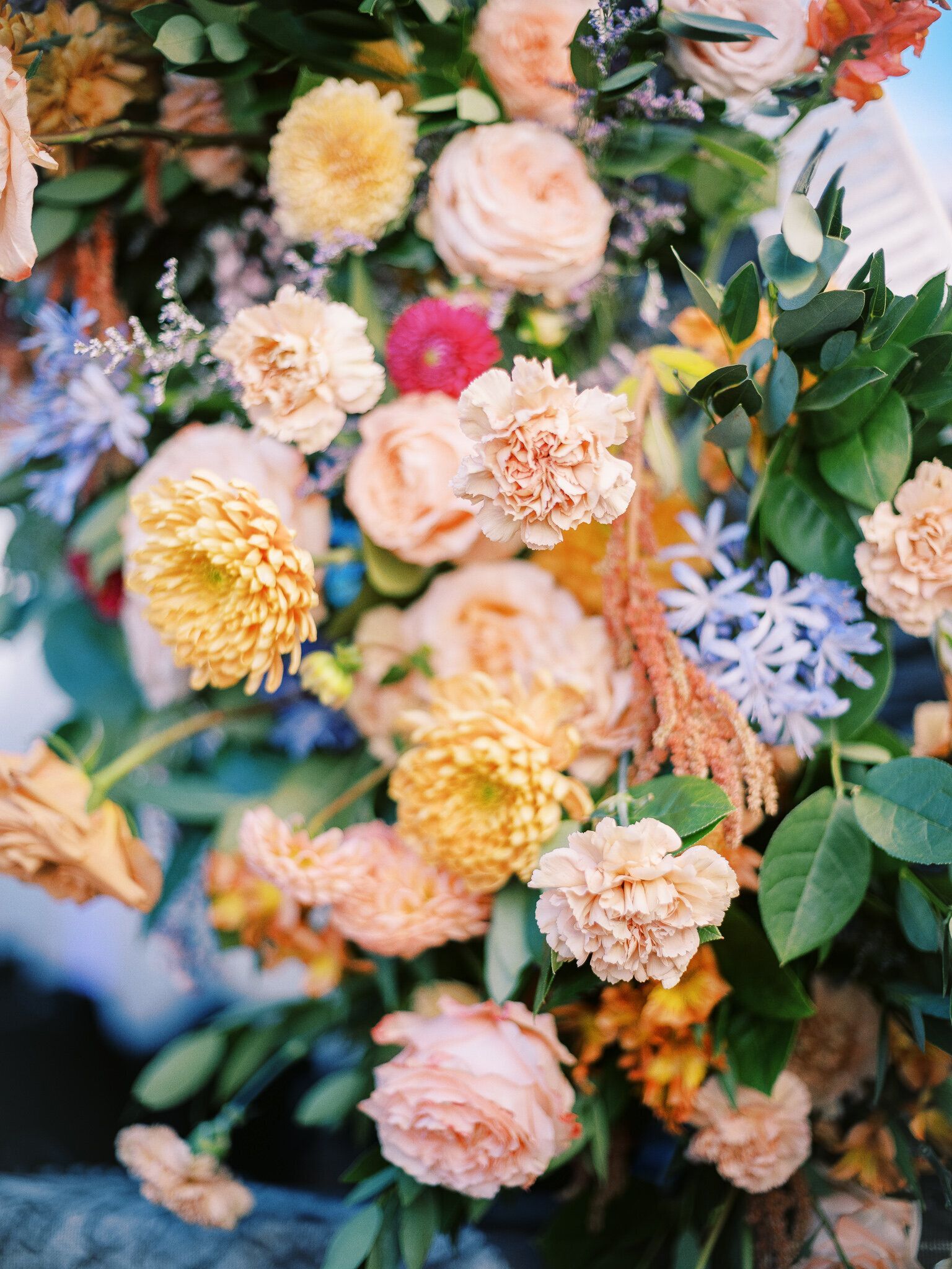 A close up of a bouquet of flowers on a table.