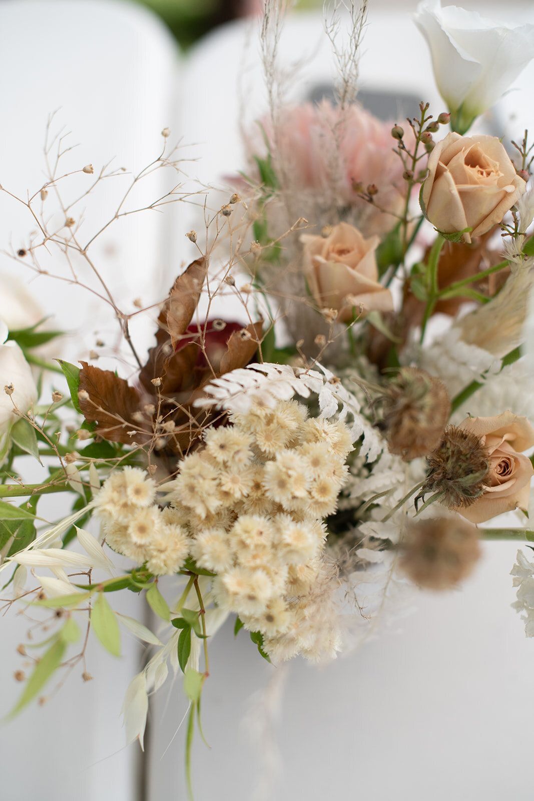 A close up of a bouquet of flowers on a table.