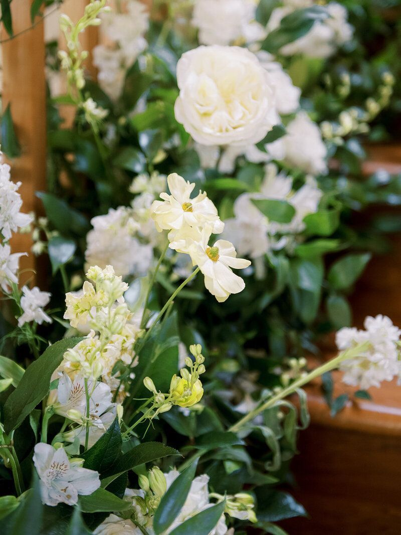 A bunch of white flowers are sitting on top of a wooden table.