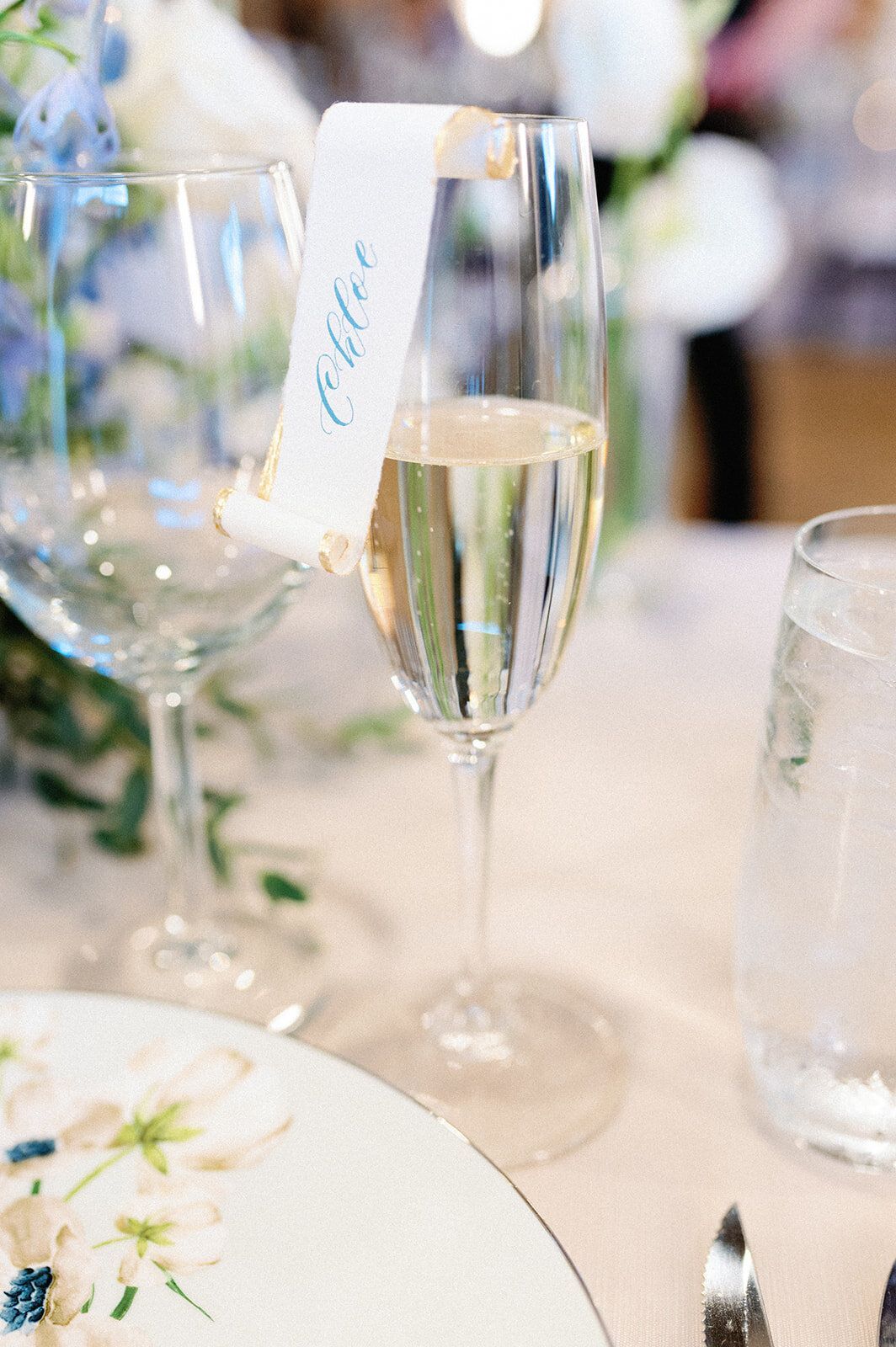 A close up of a glass of champagne on a table.