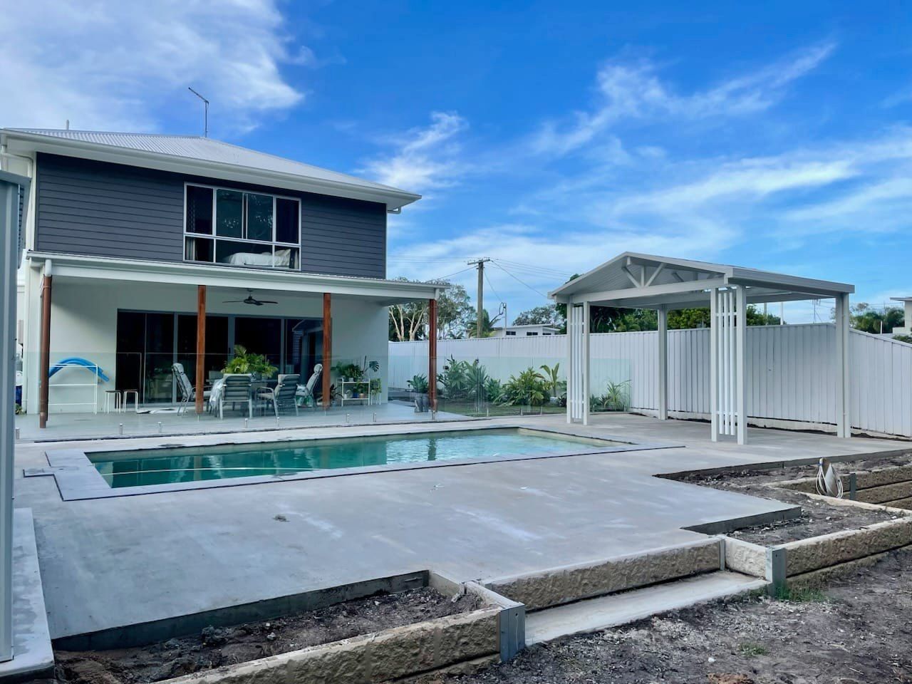 Backyard With Pool, Two-story House, Carport — Sunny Tiling Co in Mount Coolum, QLD