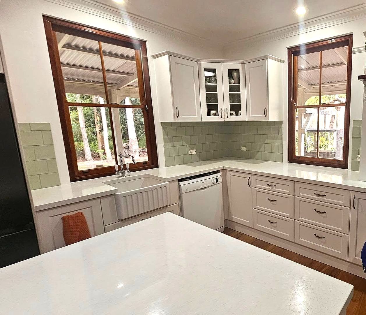 Kitchen With Light Gray Cabinets, White Countertops, and a Farmhouse Sink — Sunny Tiling Co in Mount Coolum, QLD