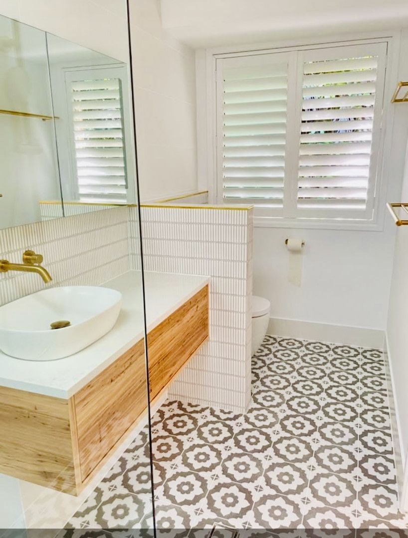 Covered patio with concrete floor, leading to a house, and a grassy yard — Sunny Tiling Co in Mount Coolum, QLD
