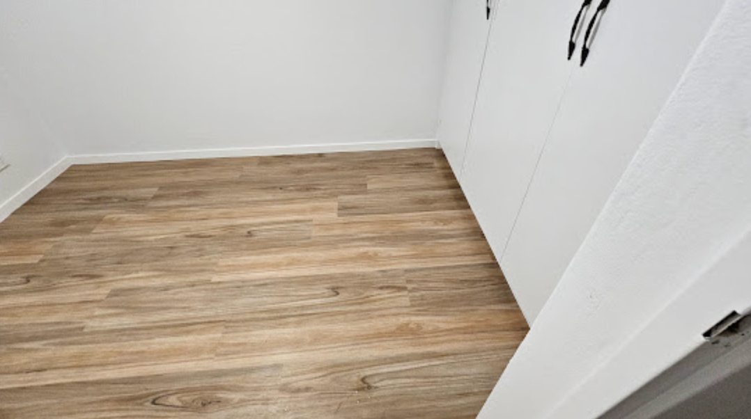 A Stack of Samples of Different Types of Wood on a Wooden Table — Sunny Tiling Co in Mount Coolum, QLD