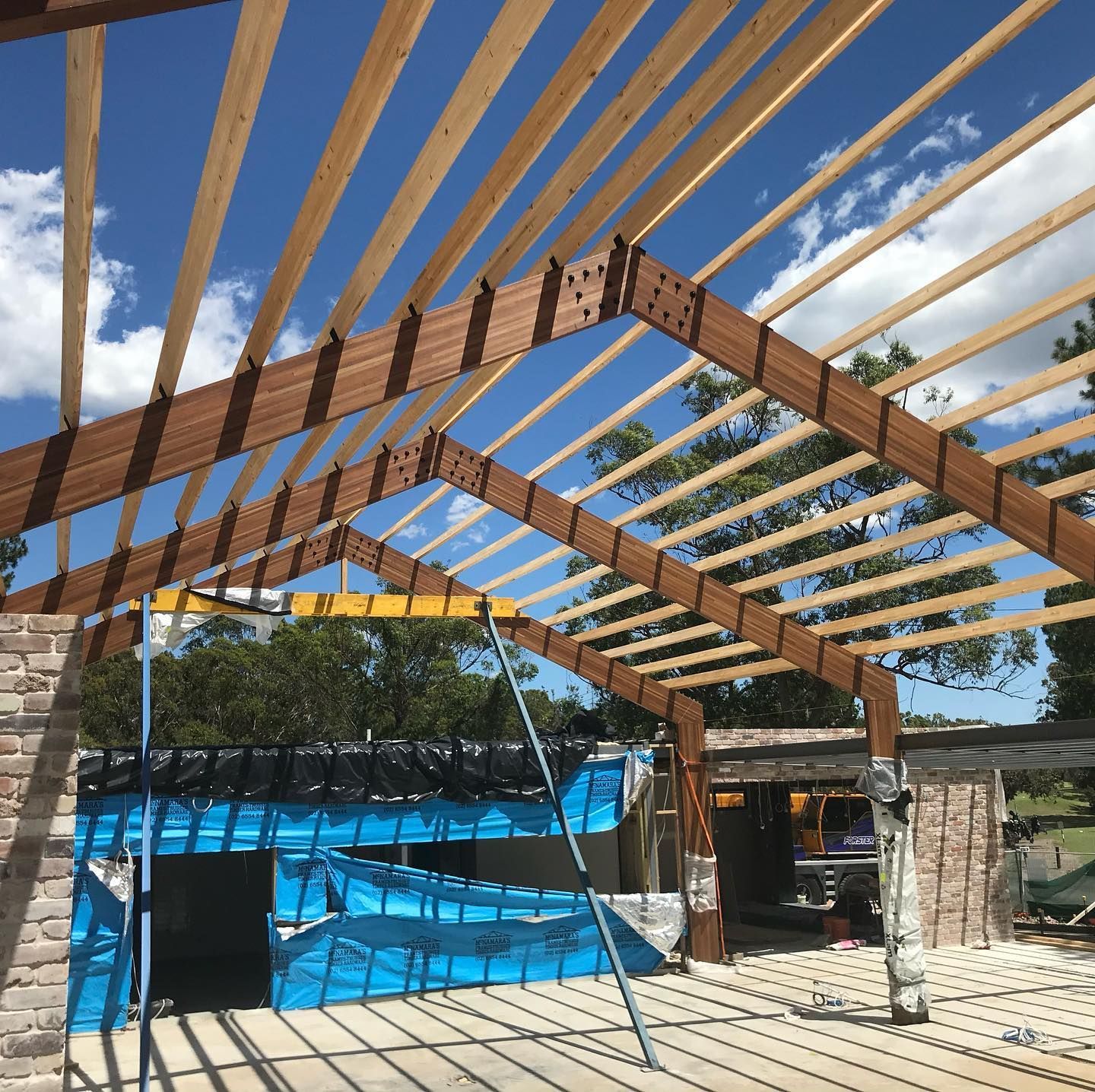 A Construction Site with Wooden Beams and Framework — Coastline Building & Renovations In Forster, NSW