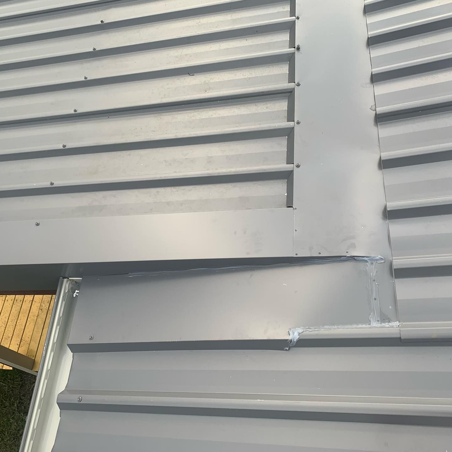 A Gray Metal Roof with Seams and Fasteners — Coastline Building & Renovations In Forster, NSW