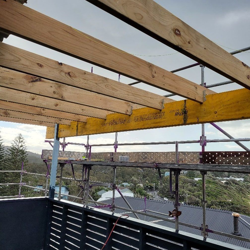 A Construction Site with Wooden Beams and Scaffolding — Coastline Building & Renovations In Forster, NSW