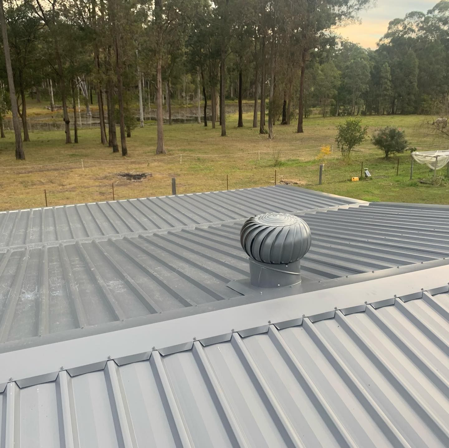 A Metal Roof with A Spinning Turbine Vent — Coastline Building & Renovations In Forster, NSW