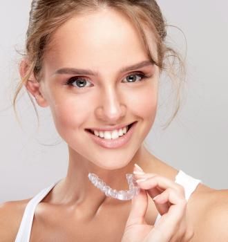 Woman holding invisalign
