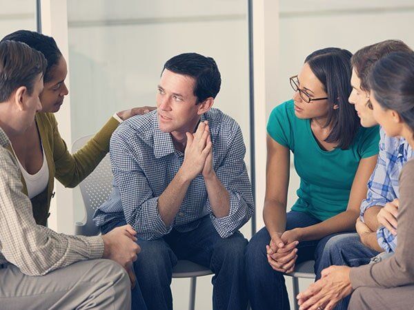 Woman Advising a Man in Group Therapy - Group Therapy in Warrenton, VA