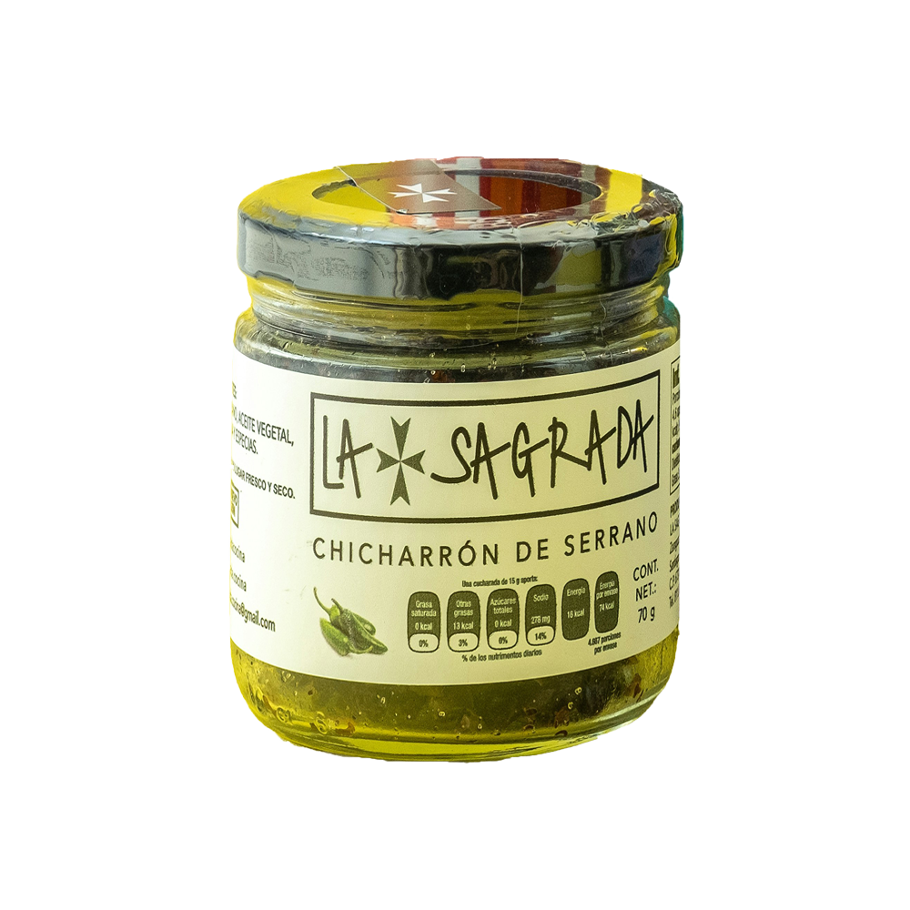 Small glass jar of yellow chicharrón de serrano with a silver lid and handwritten label.