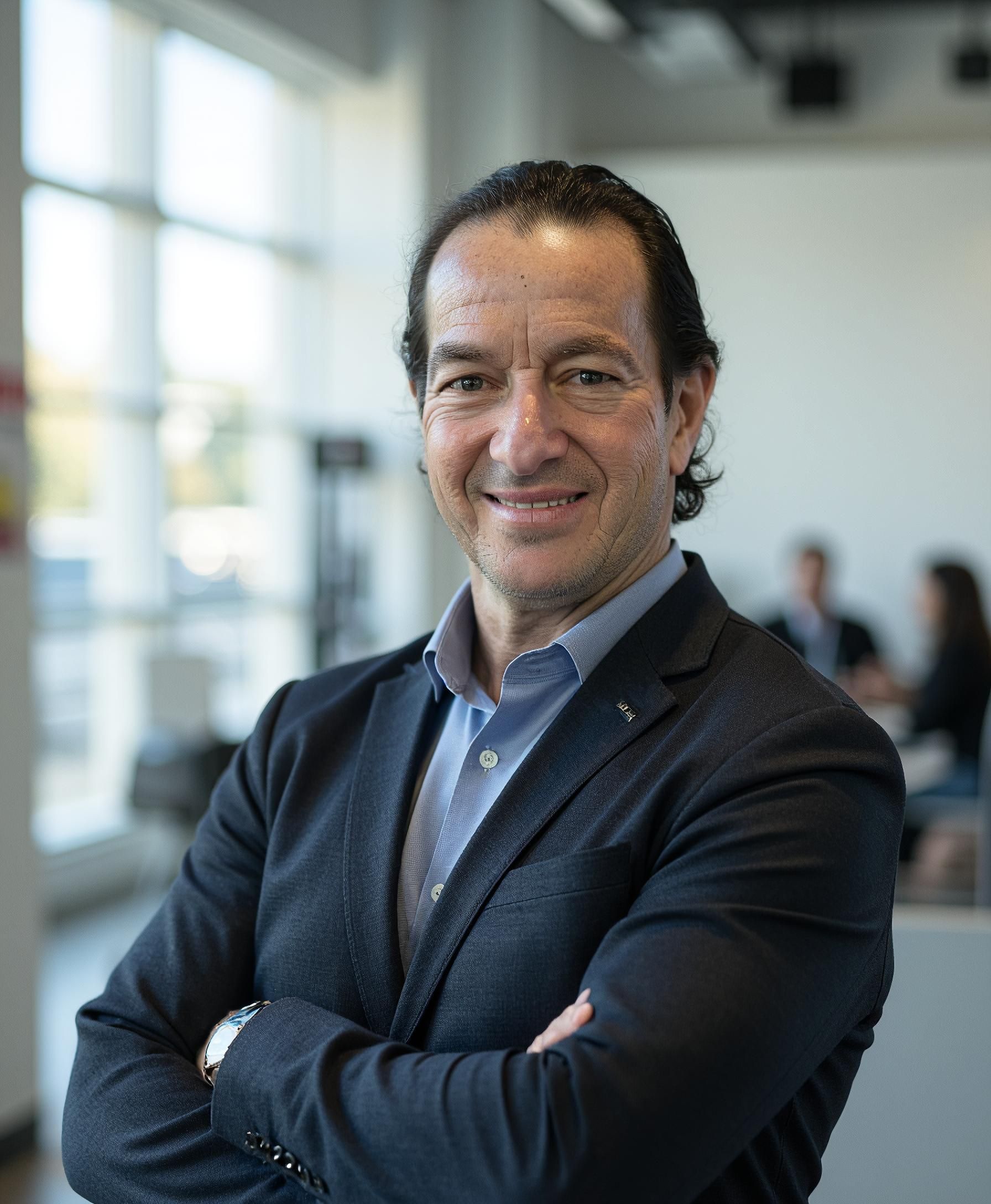 A man in a white shirt is smiling for the camera.