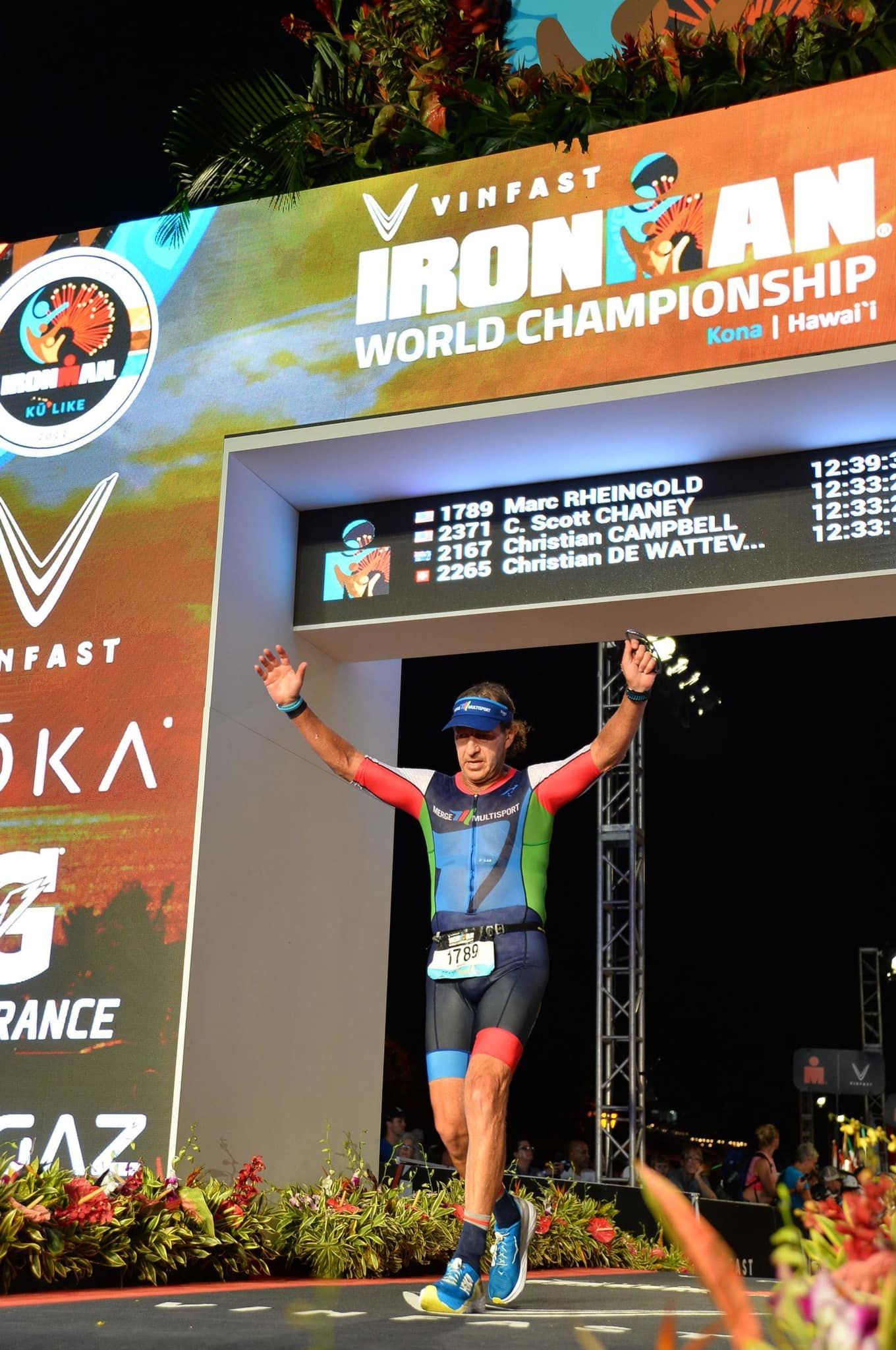 A man is standing in front of a sign that says ironman world championship