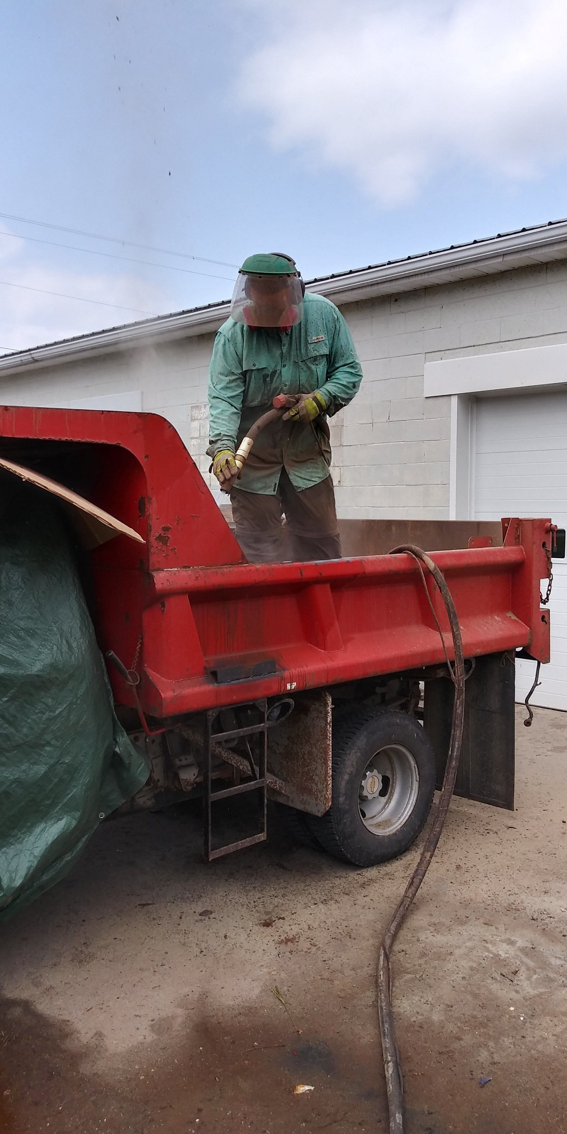 Keystone's Staff Blasting the Red Truck's Bed — Indiana, PA — Keystone Dustless Mobile Media Blasting LLC