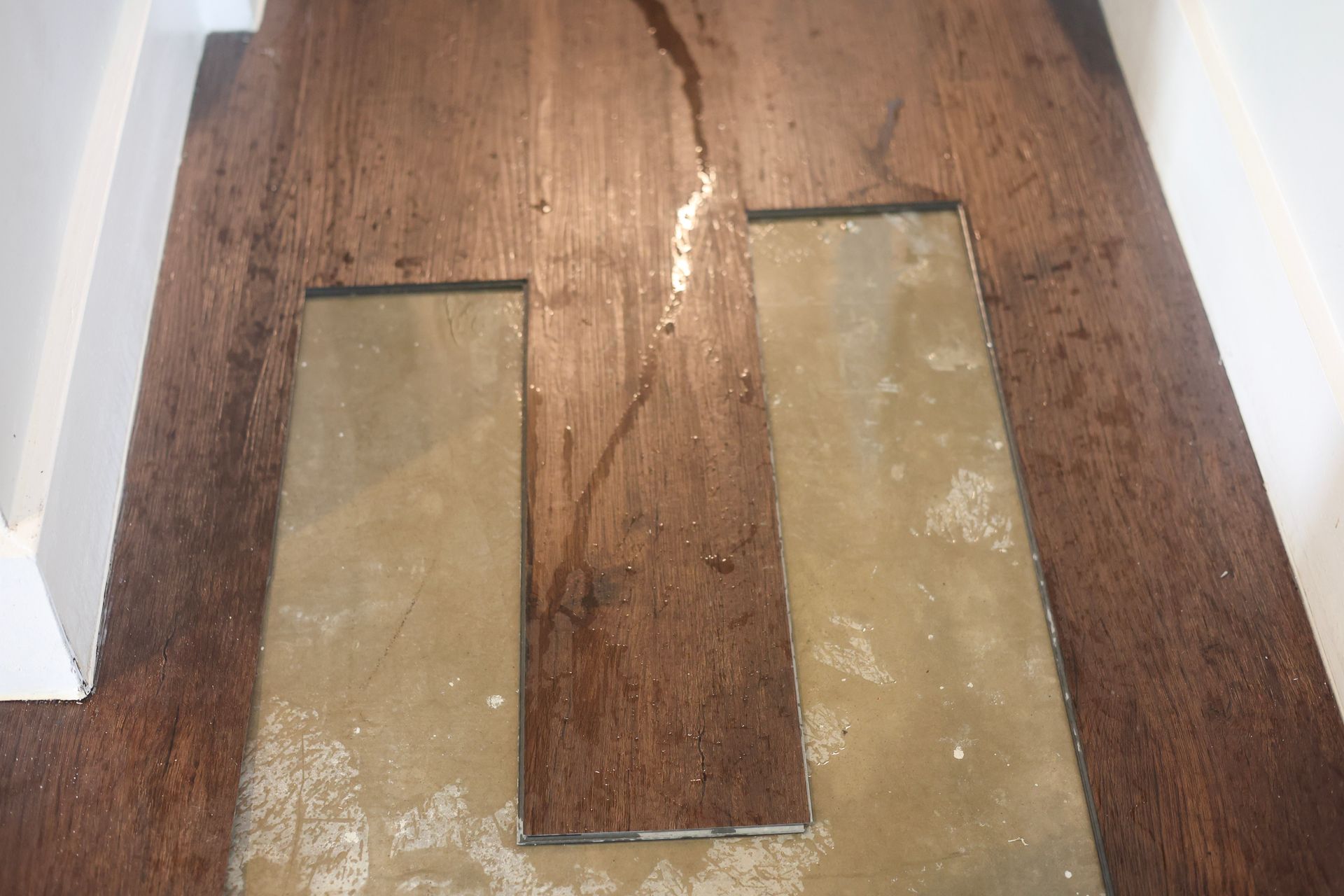 Water damage on flooring caused by slab leak.