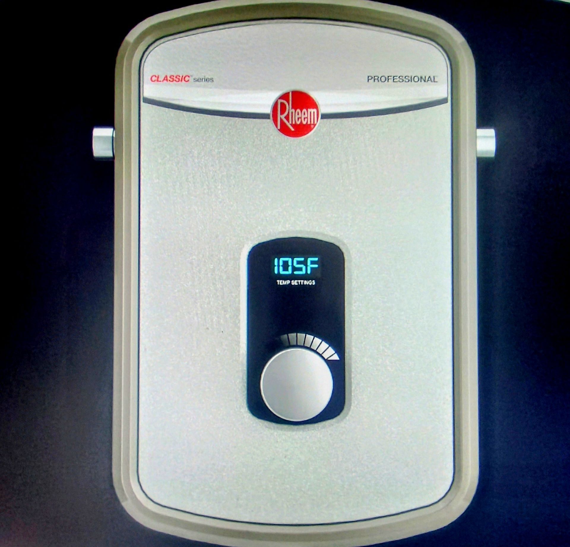 Rheem tankless water heater mounted on a wall, showing a digital display set to 105 degrees Fahrenheit with a control knob.