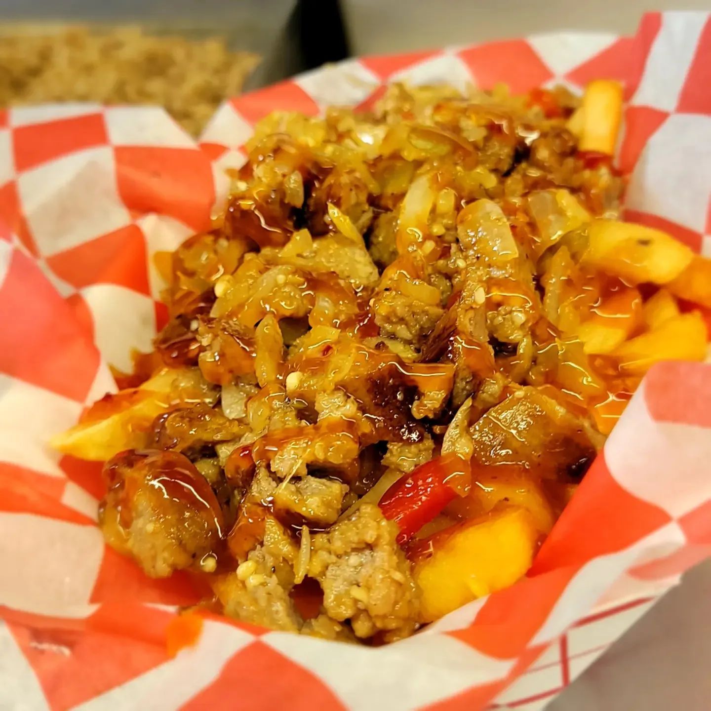 A close up of a bowl of food on a checkered paper.
