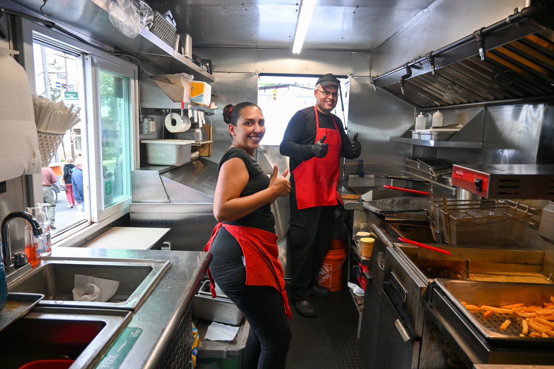 A man and a woman are standing in a kitchen.