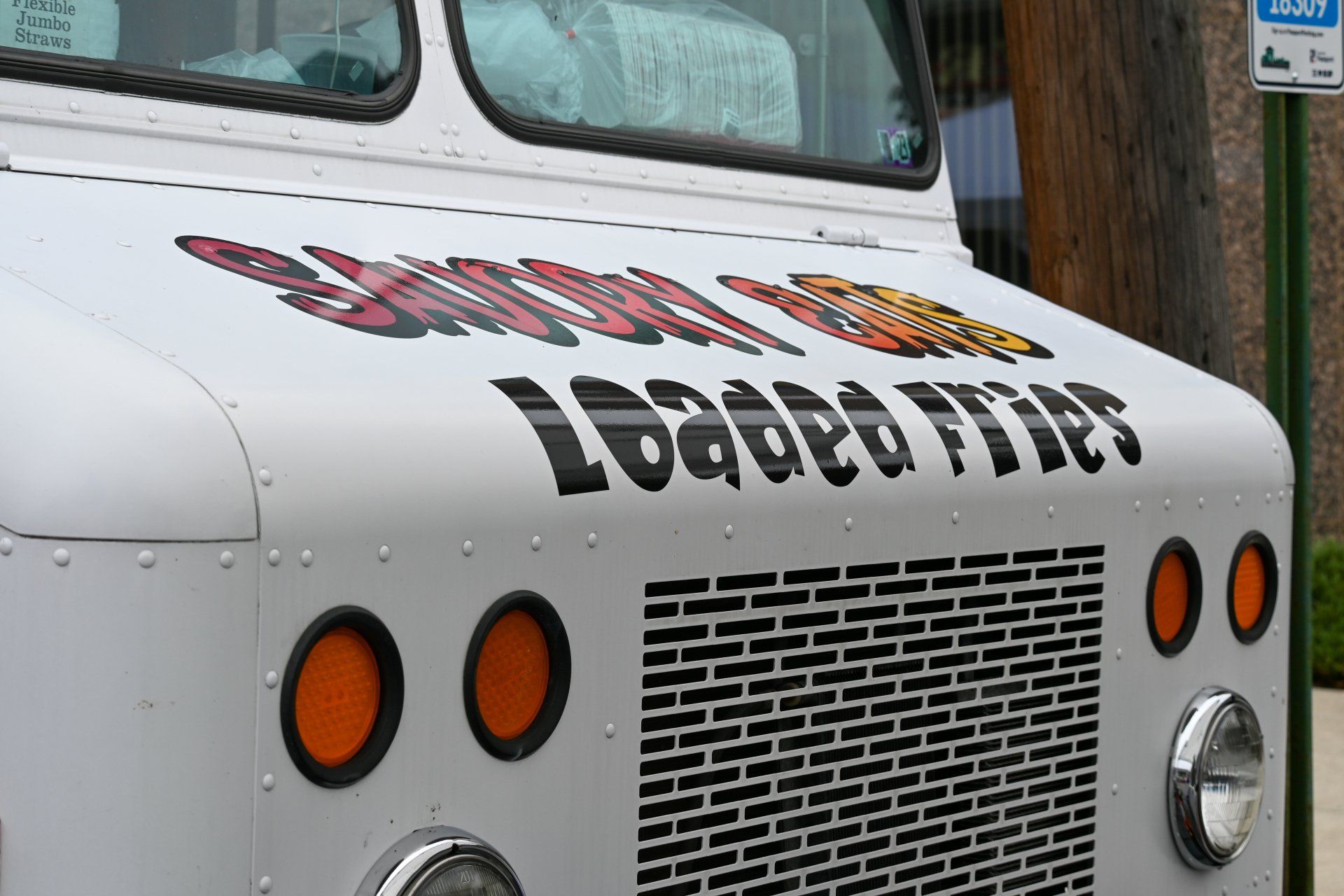 A white truck with the word loaded tires on the front