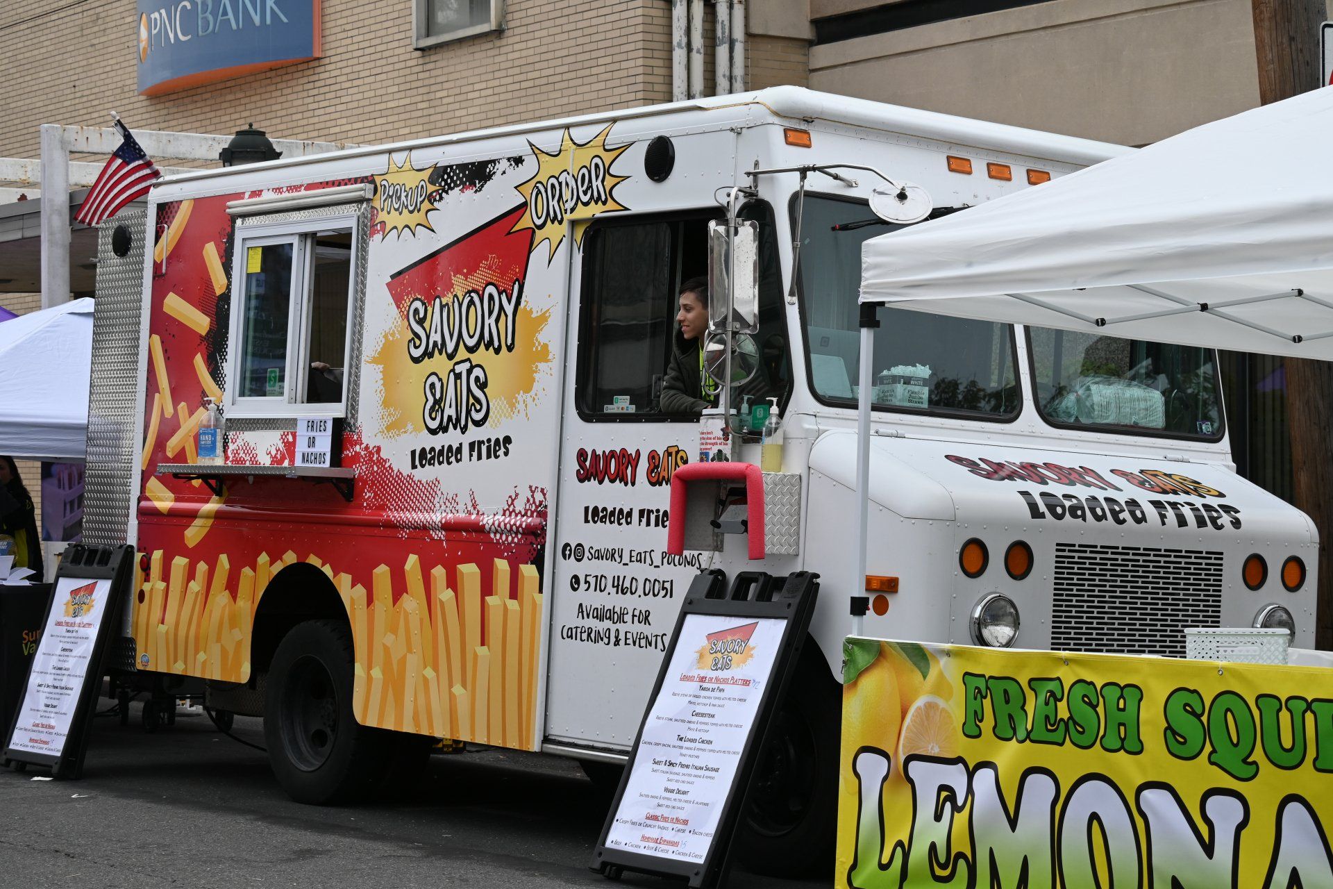 A food truck with a sign that says fresh squeezed lemonade