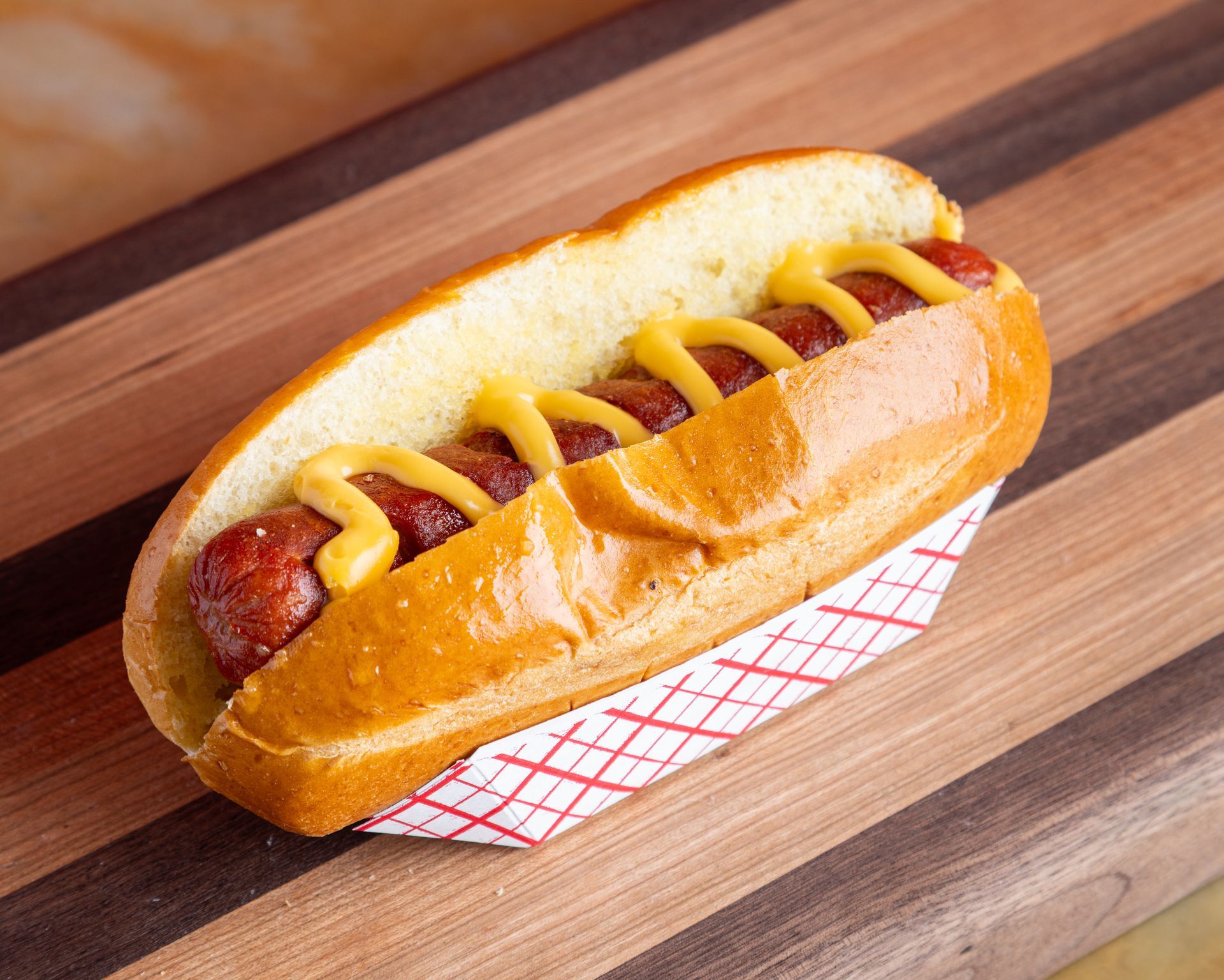 A man in a red apron is preparing food in a kitchen.