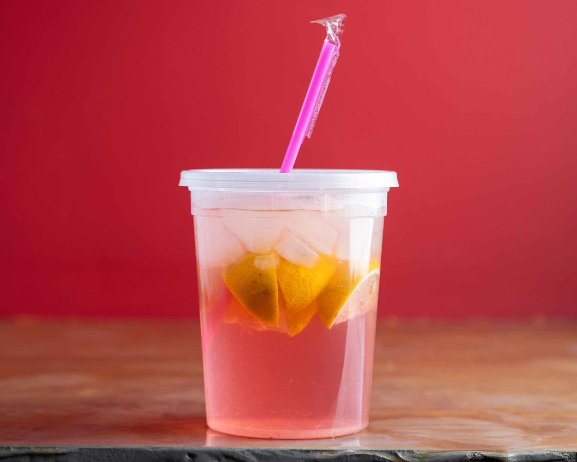 A close up of a glass of iced coffee on a table.