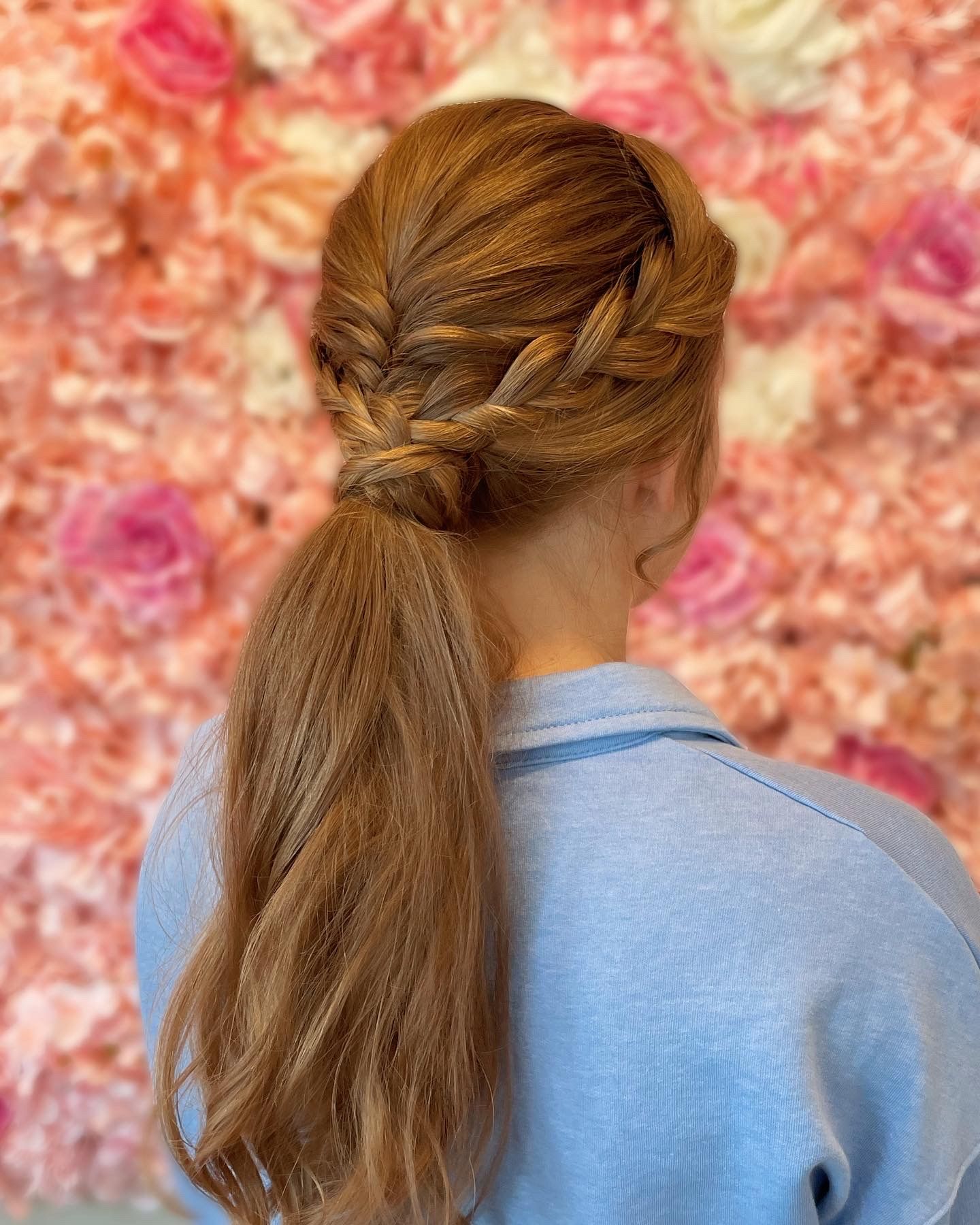 A woman is getting her hair dyed by a hairdresser in a salon.