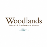 Woodlands Motel & Conference Venue logo in brown and teal on a white background