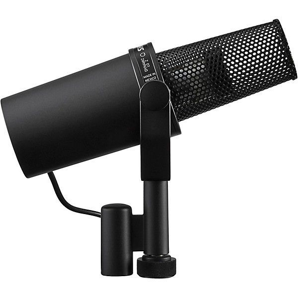 Black Shure SM7B microphone with a foam windscreen on a stand.