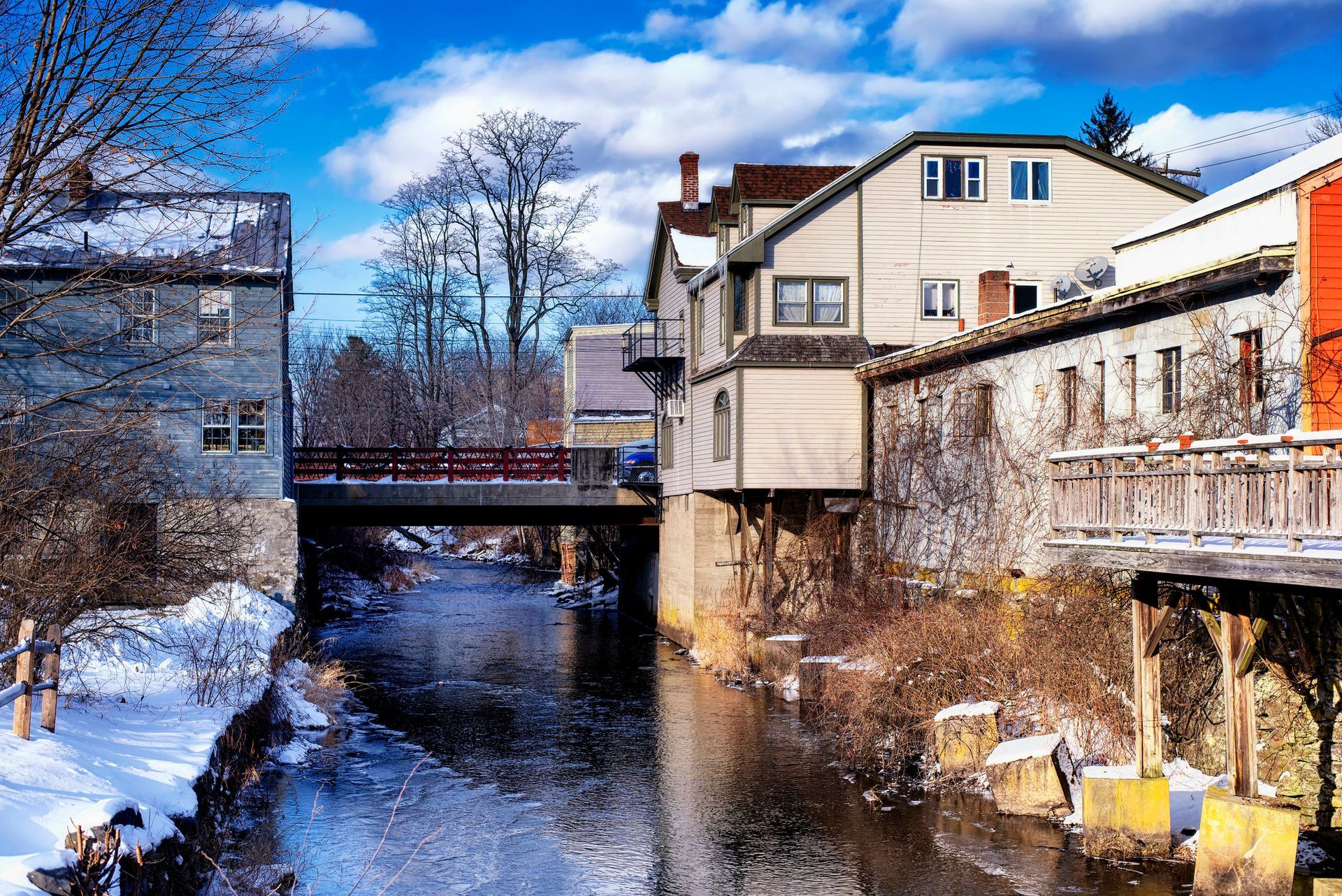 There is a bridge over a river in the middle of a small town.