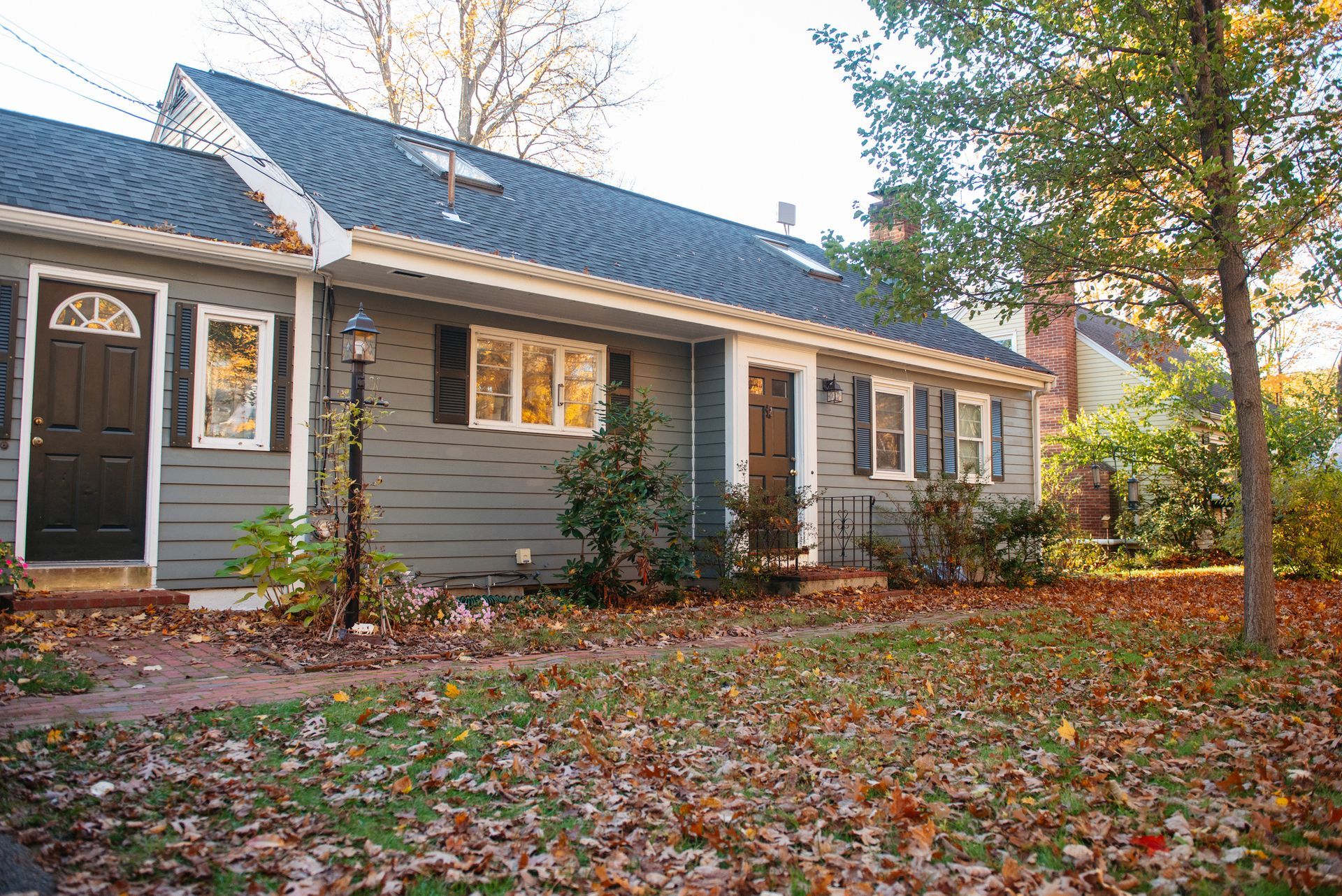 A house with a blue roof and a black door