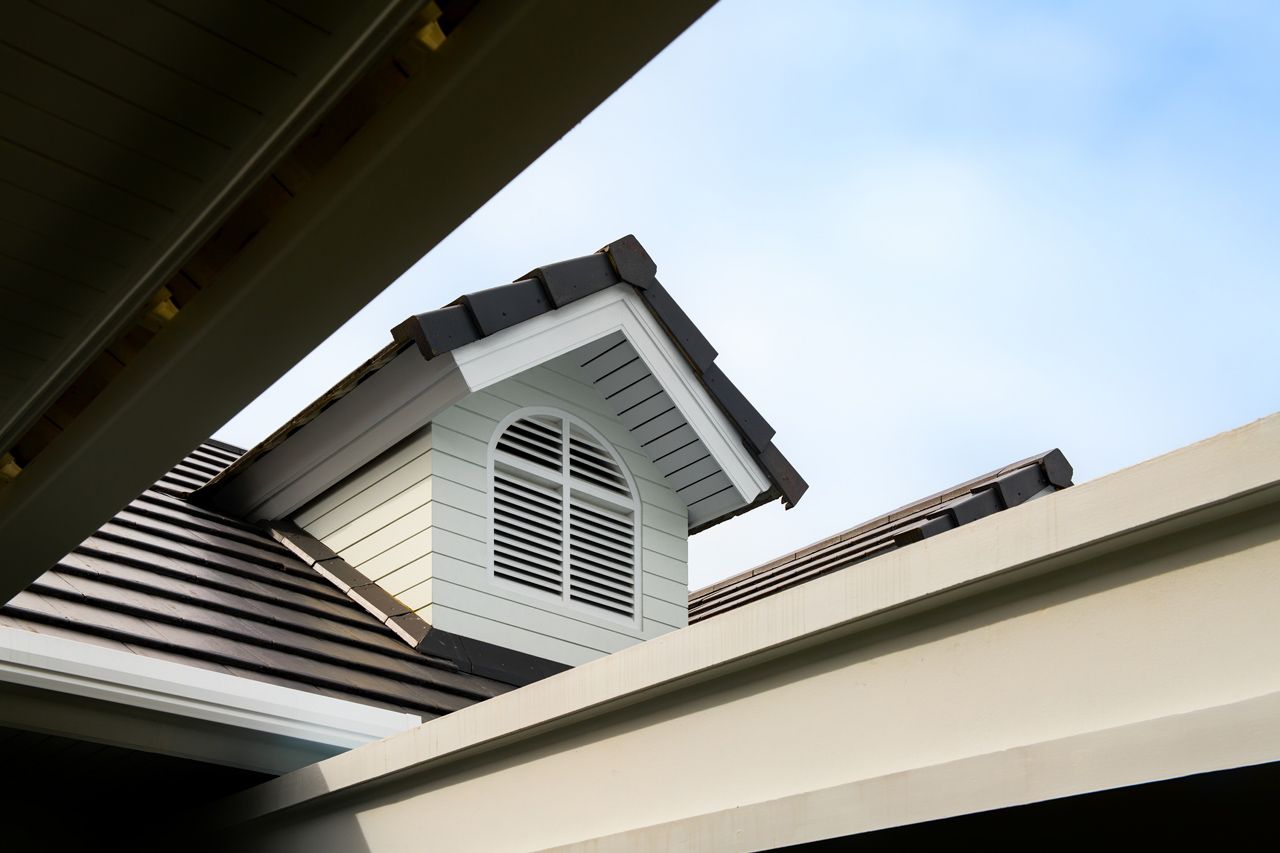 Looking up at the roof of a house with a window